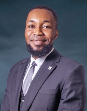 Smiling light-skinned African man in a three-piece suit