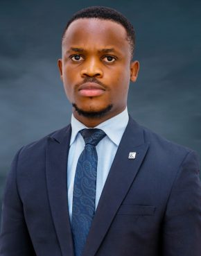 Light skinned African man in blue shirt, blue tie and dark blue suit