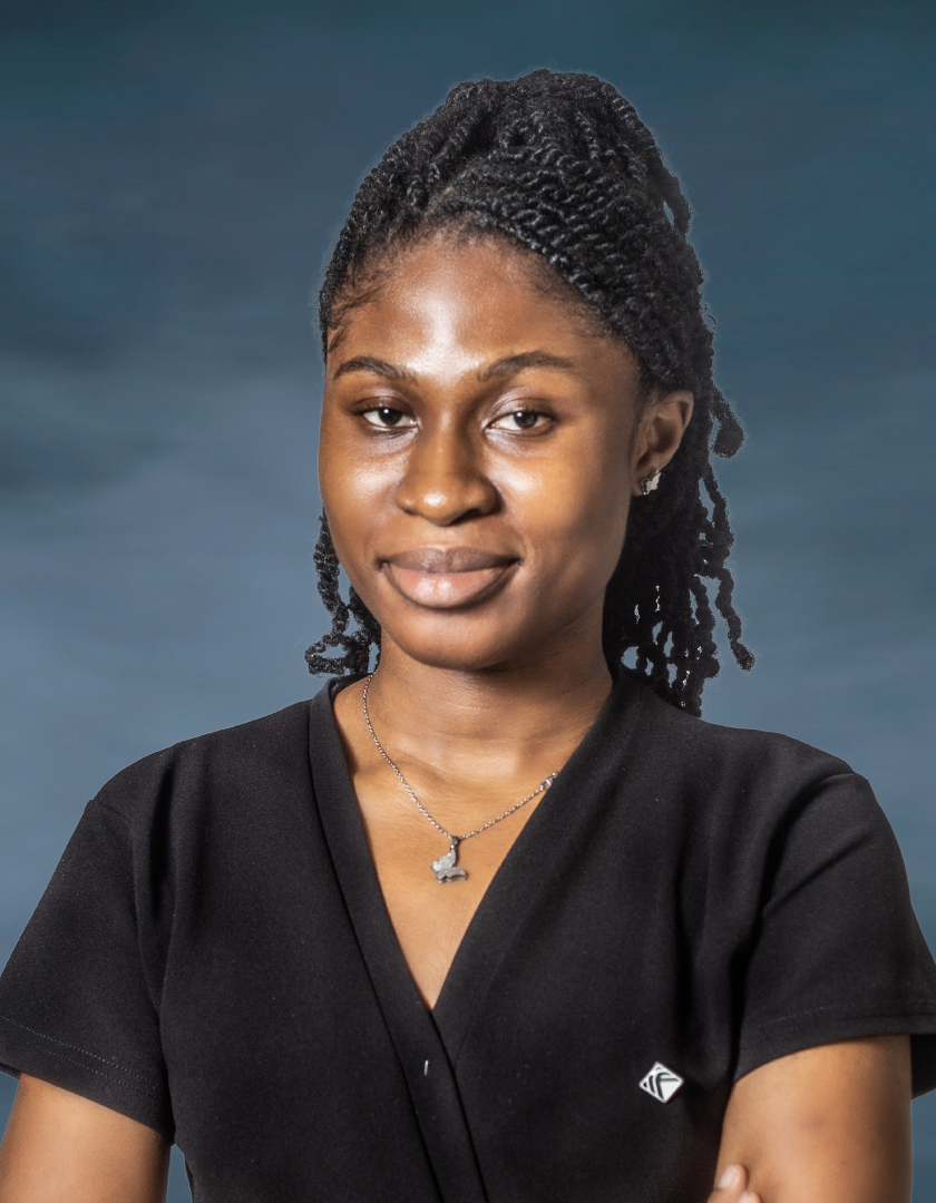 African lady in a black dress wearing a silver chain with pendant and on dreads