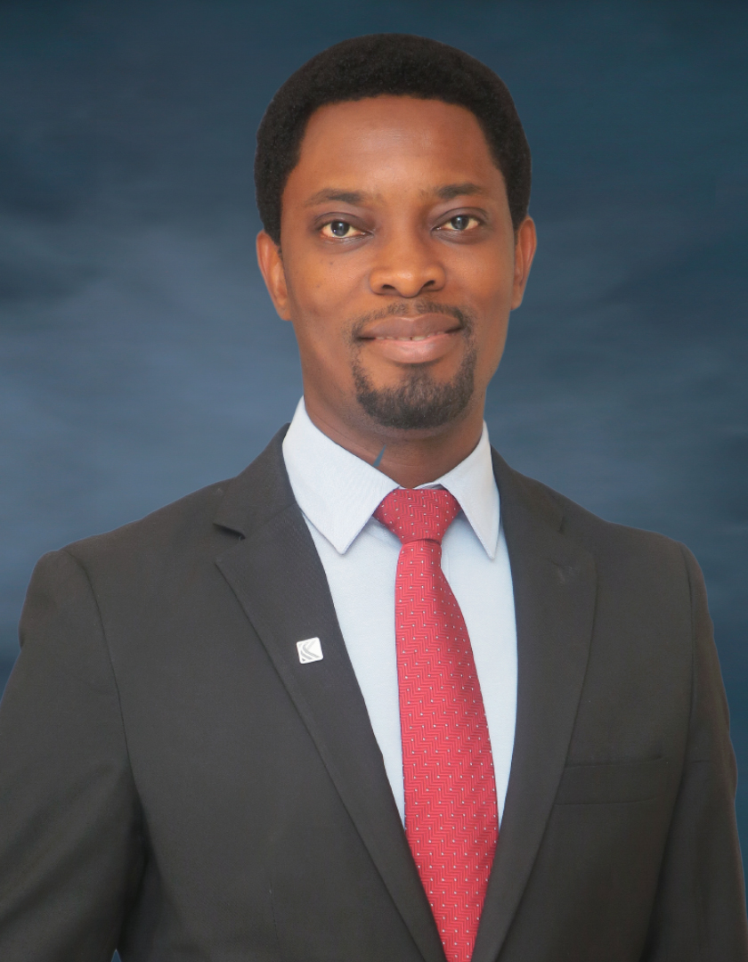 African man in brown suit and red tie