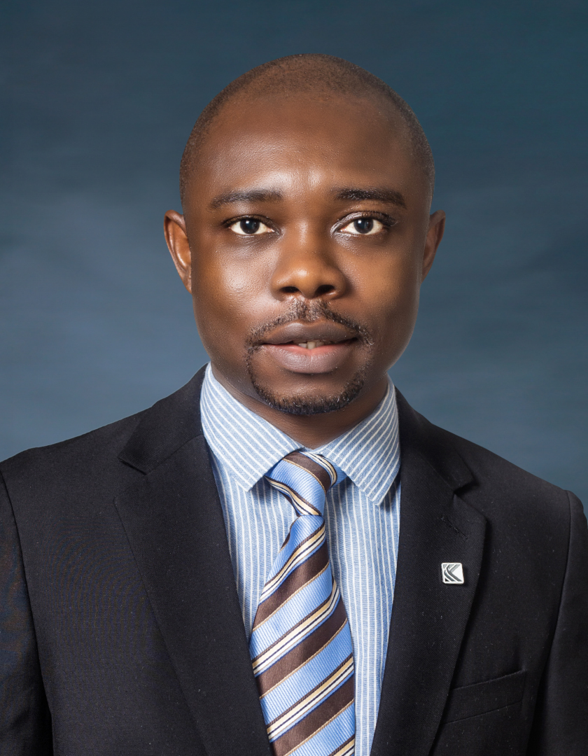 African man in a black suit and multi-coloured tie