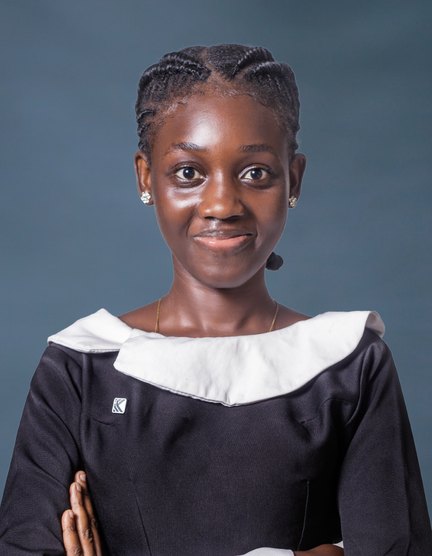 African lady in cornrows and a black and white dress