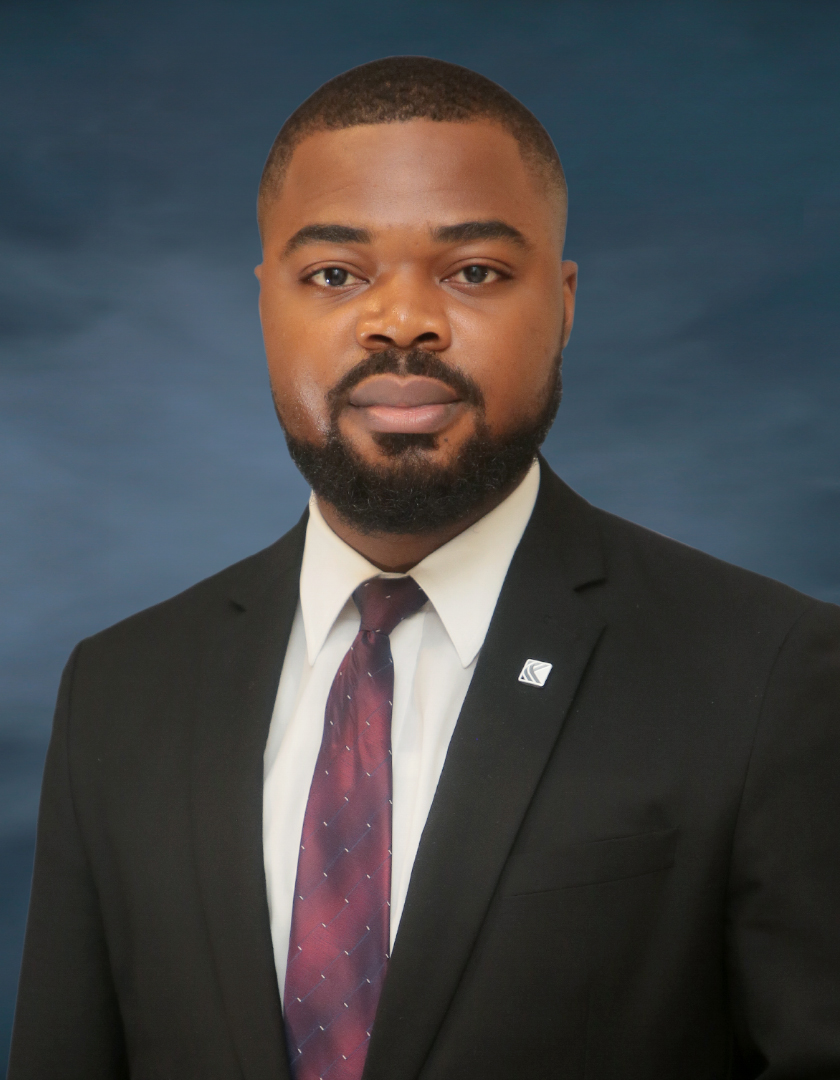 Bearded African man in a dark suit and a blue striped tie