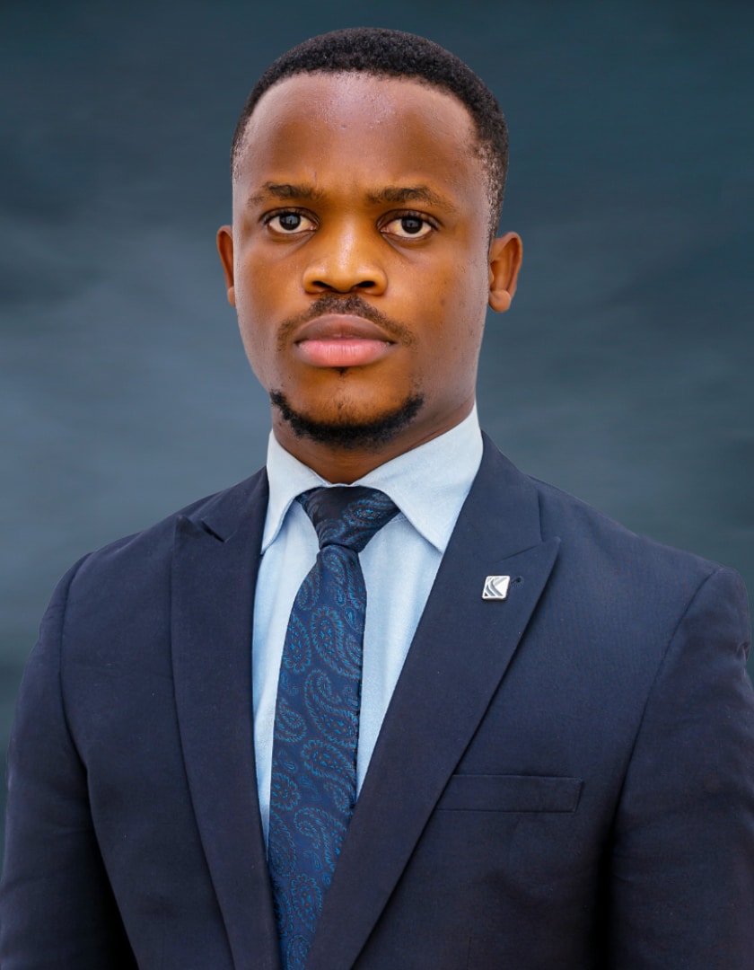 Light skinned African man in blue shirt, blue tie and dark blue suit