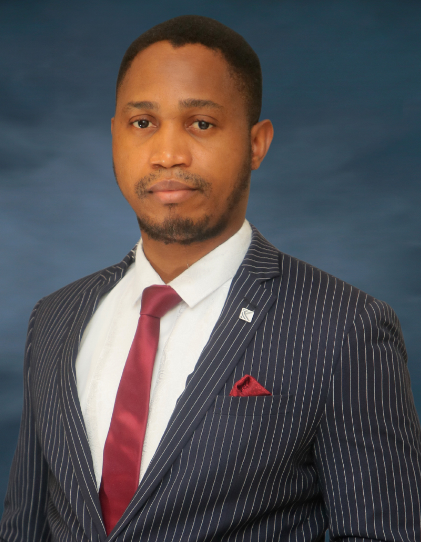 Light-skinned African man in striped black suit with red tie and pocket square