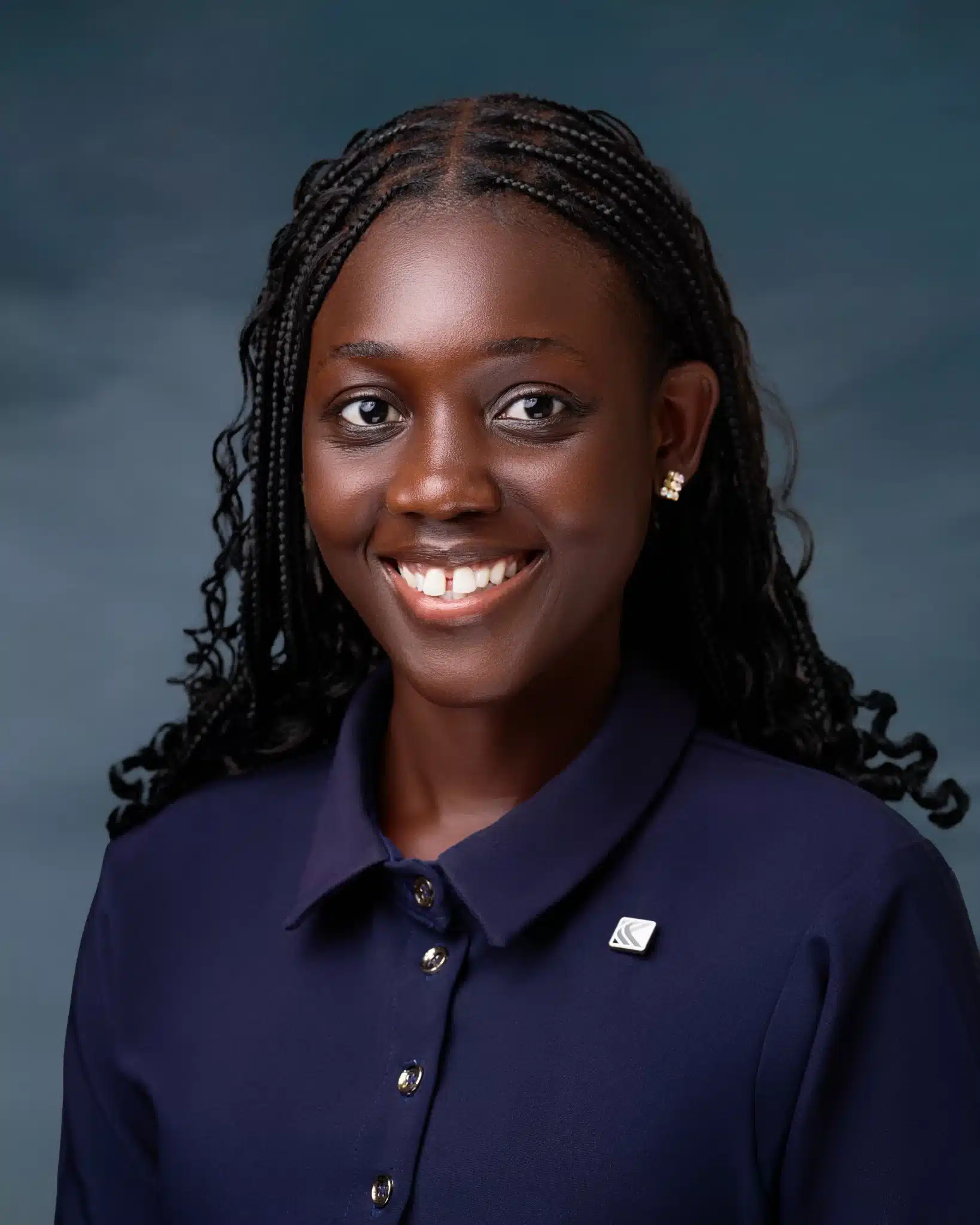 Smiling dar-skinned African woman in a blue blouse and long dark hair