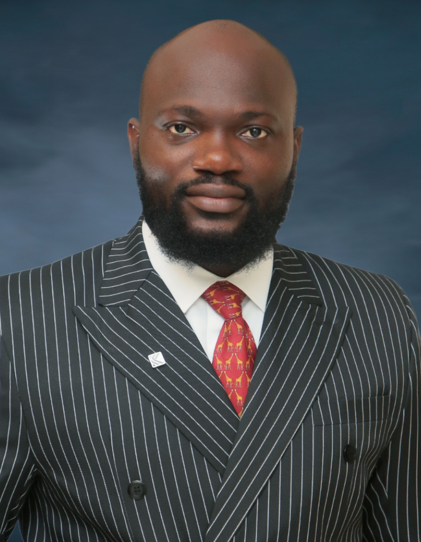 Bald headed and bearded African man in striped suit and orange tie