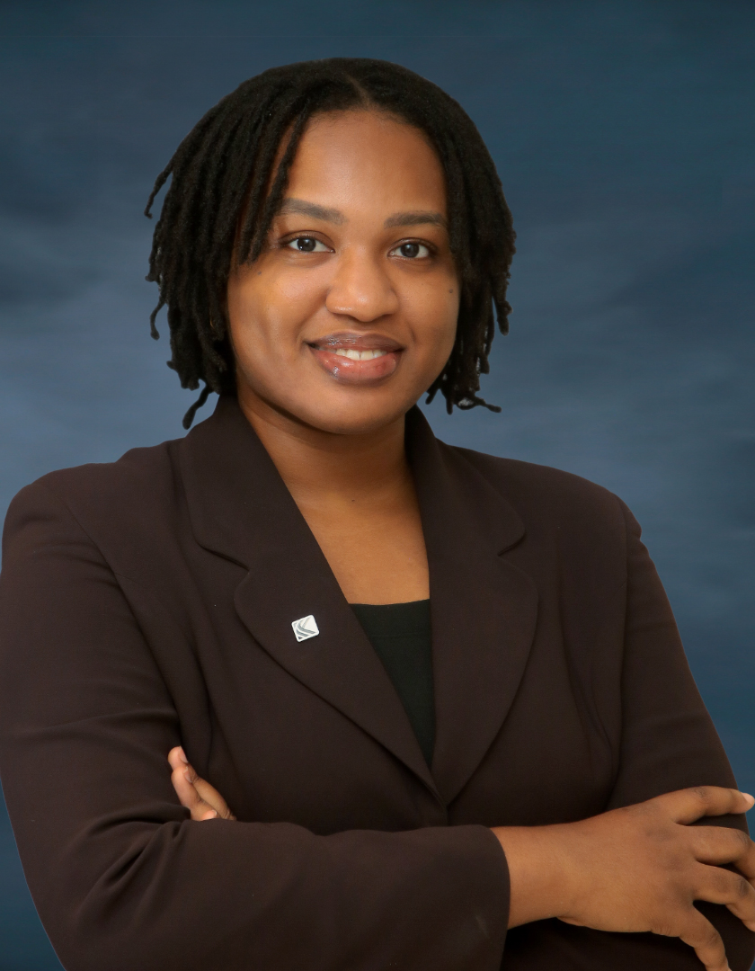 Smiling light-skinned African women in dreads and brown corporate suit