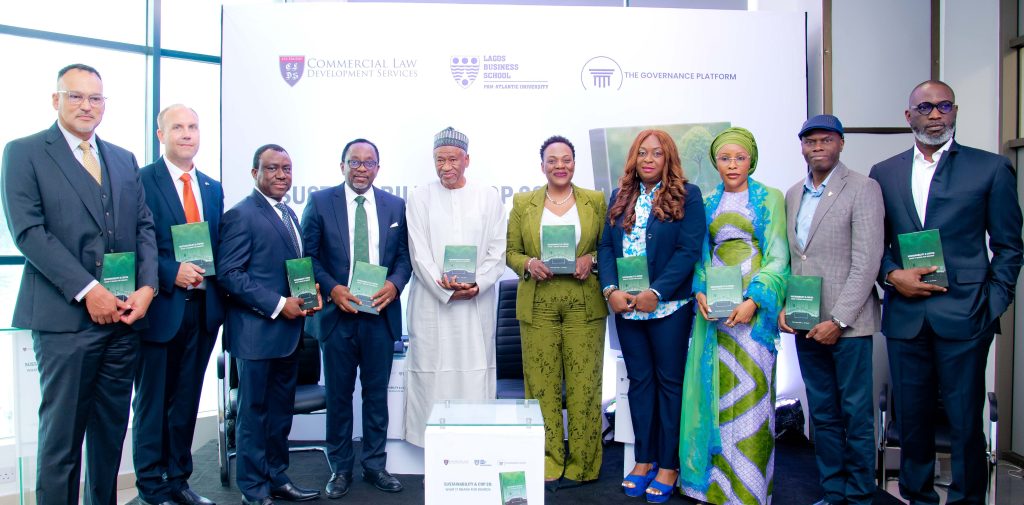 10 dignitaries on stage holding copies of the book Sustainability & COP 28: What It Means for Boards, at the launch of the book.