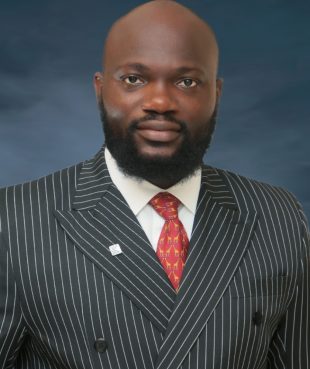 Bald headed and bearded African man in striped suit and orange tie