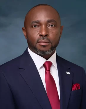 Dark-skinned African man in a blue jacket, salt-and pepper beards, red tie and pocket square