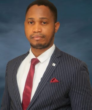 Light-skinned African man in striped black suit with red tie and pocket square